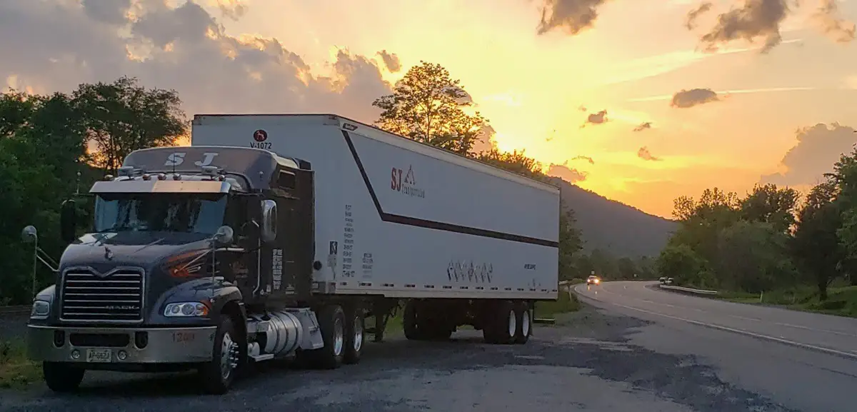 Truck with beautiful sunset behind it